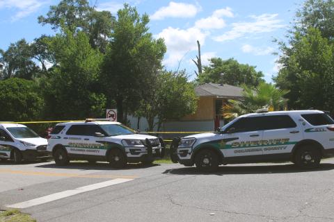 Columbia County Sheriff’s Office vehicles are parked outside a NW Long Street residence where a deputy was injured during a drug bust Wednesday morning. (TONY BRITT/Lake City Reporter)