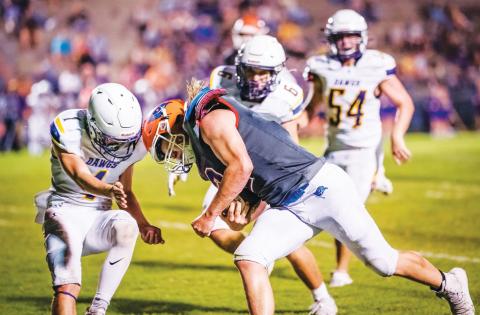 Branford running back Caden Coker meets a Bell defender during the teams’ matchup last September. The teams will face off again this fall on Sept. 9. (BRIAN LEWIS/Special to the Reporter)