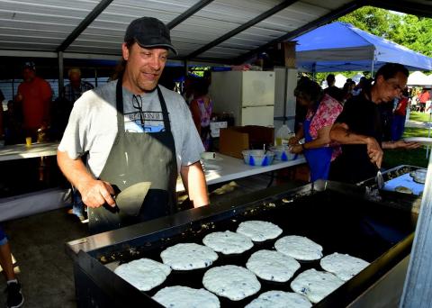 Rob Dawson with the Wellborn Community Association watches over a batch of blueberry pancakes Saturday morning during the 29th annual Wellborn Blueberry Festival. (ROB WOLFE/Special to the Reporter)