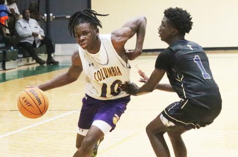 Columbia guard Isaac Broxey drives to the basket against St. John Paul II during the team’s shot clock league on June 8 at FGC. (JORDAN KROEGER/Lake City Reporter)