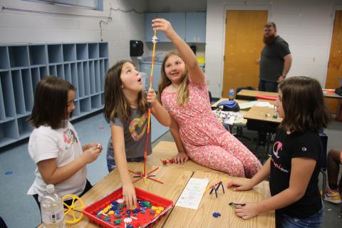 Macy Sirard (from left), Sadie Breeden, Rylee Lupton and Amira Estrada work on building a tower using K’NEX parts on Thursday morning while attending the STEAM summer program at Summers Elementary School. (TONY BRITT/Lake City Reporter)