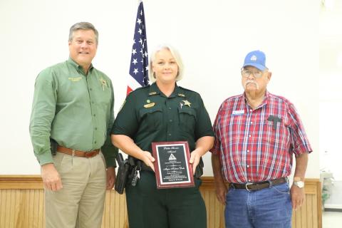 Maj. Katina Dicks (center) accepts her award at Tuesday’s Columbia County Farm Bureau dinner. (MORGAN MCMULLEN/Lake City Reporter)