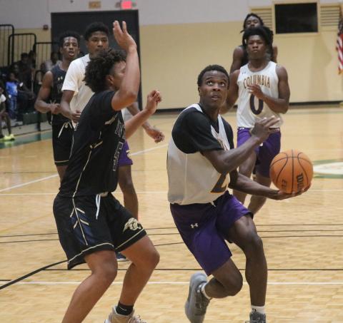 Columbia forward Seth Stockton drives to the basket during Tuesday night’s scrimmage against St. John Paul II at the Howard Center. (JORDAN KROEGER/Lake City Reporter)