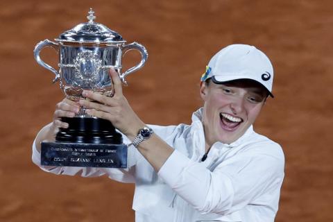 Iga Swiatek celebrates with the cup after defeating Coco Gauff in the French Open final at the Roland Garros Stadium on Saturday in Paris. Swiatek won 6-1, 6-3. (JEAN-FRANCOIS BADIAS/Associated Press)