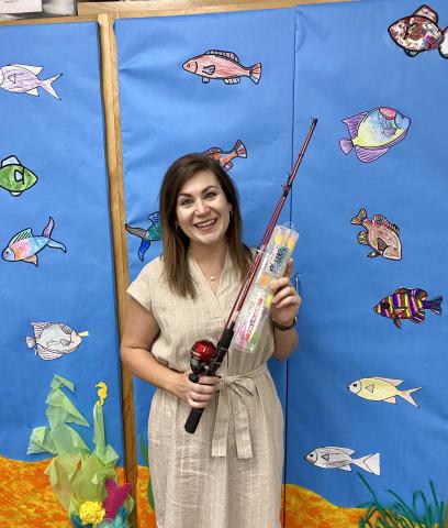 Columbia County Public Library Youth Services Librarian Kate Duong shows off the rod and reel, donated by Fish Florida, that children can receive at the June 24 adventure at Alligator Lake Park. (COURTESY)