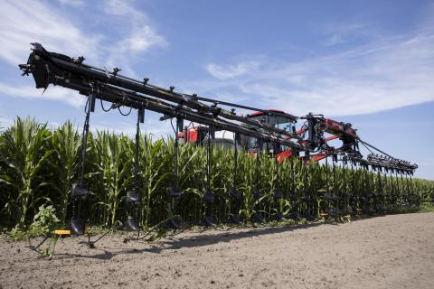 An elevated tractor applies fertilizer to a corn field in May. UF/IFAS is looking to conduct new research on the best management practices for key crops, including how much fertilizer to use. (COURTESY UF/IFAS)
