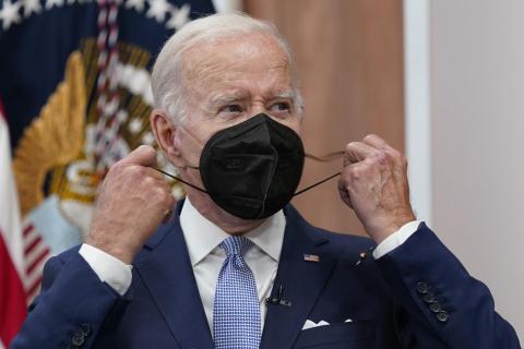 President Joe Biden removes his face mask as he arrives to speak about the economy during a meeting with CEOs in the South Court Auditorium on the White House complex on July 28, Washington. (SUSAN WALSH/Associated Press)