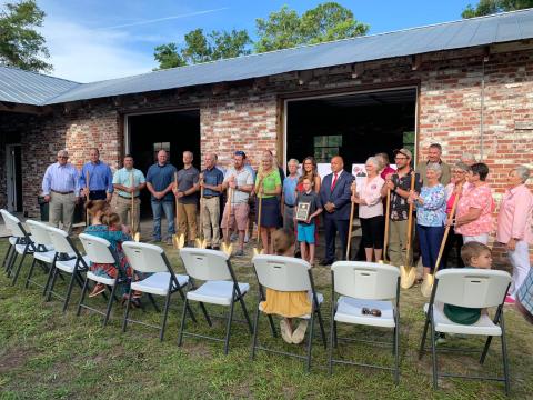 Friends, family and coworkers of J. Don Allen gather for the ceremonial groundbreaking of the J. Don Allen Cultural Center at Heritage Park and Gardens on Friday. (COURTESY)