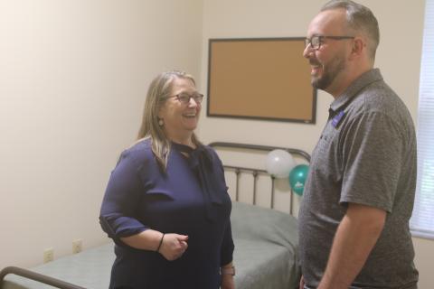 Joy Riddle, a senior vice president at Meridian, shares a laugh with Joey O’Hern, the executive director of the Lake City-Columbia County Chamber of Commerce, while showing him one of the residential rooms in the 16-bed facility. (TONY BRITT/Lake City Reporter)