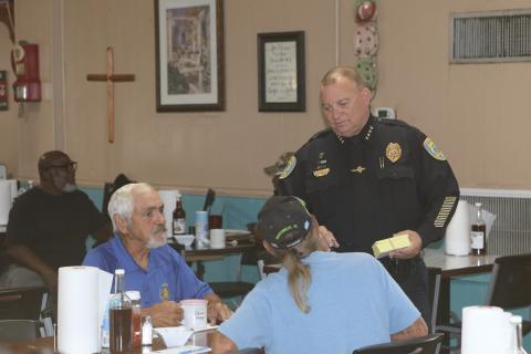 Lake City Police Department Chief Gerald Butler (right) speaks with a pair of diners at Kountry Korner on Saturday. (TONY BRITT/Lake City Reporter)