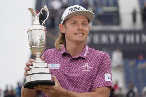 Cameron Smith holds the claret jug trophy as he poses for photographers on the 18th green after winning the British Open on the Old Course at St. Andrews on Sunday in Scotland. (GERALD HERBERT/Associated Press)