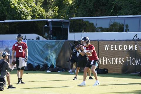 Jacksonville Jaguars quarterback Trevor Lawrence (right) takes a snap as quarterback C.J. Beathard (3) looks on during practice on Monday in Jacksonville. (JOHN RAOX/Associated Press)