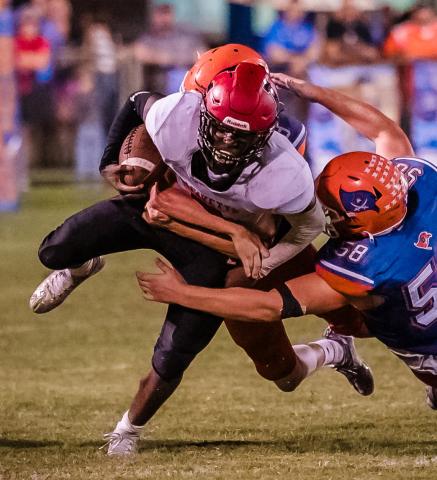 Lafayette running back Johntavious Cook is tackled by Branford’s Matt Warren last season. (BRIAN LEWIS/Special to the Reporter)
