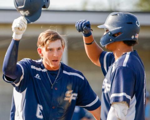 Santa Fe’s Tyler Shelnut (left) celebrates after scoring a run during a game this past season. (COURTESY OF SANTA FE ATHLETICS)
