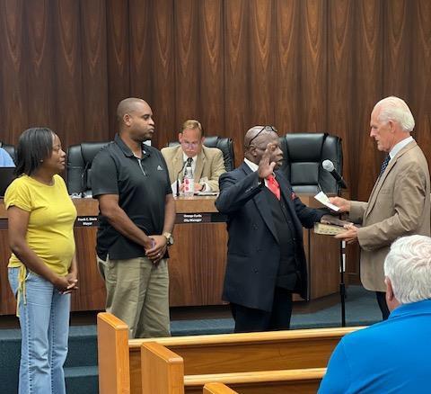 Tommie Jefferson takes the oath of office for the Live Oak City Council from Mayor Frank Davis on Tuesday as he is joined by friends for the occasion. (COURTESY)