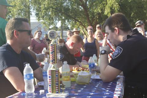 Suwannee County Fire Rescue Captain Chip Leathlean (left) takes a moment during Monday’s inaugural Rudy’s Dawgs Hot Dog Eating Contest. (JAMIE WACHTER/Lake City Reporter)