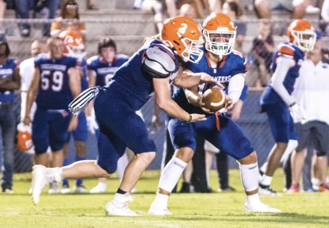 Branford quarterback Cohen David hands the ball off to running back Caden Coker during last Friday’s Preseason Classic against Fort White. (CHRISTINA FEAGIN/Special to the Reporter)
