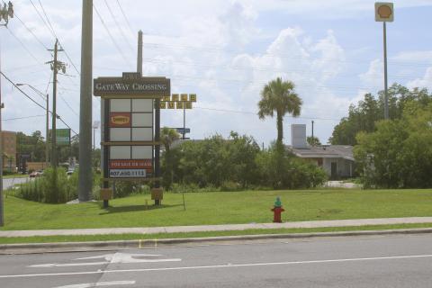 A sign for Gateway Crossing sits at the intersection of NW Centurion Court and U.S. 90, near the proposed sites of Sonic Drive-In and RibCrib restaurants. (JAMIE WACHTER/Lake City Reporter)