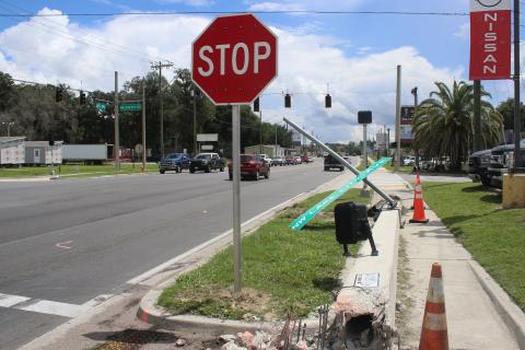 A downed crosswalk pole sits on the sidewalk near the intersection of U.S. Highway 90 and Lake City Avenue Monday afternoon after a single-vehicle crash took it down Sunday morning. (TONY BRITT/Lake City Reporter)