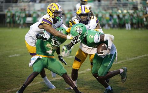 Columbia safety Amare Ferrell (top left) and cornerback Kani Fulton (top right) go in to tackle Suwannee kick returner Jay Smith during last Friday’s Preseason Classic. (BRENT KUYKENDALL/Lake City Reporter)