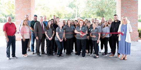 ACV Health cuts the ribbon to launch its rebrand Aug. 25 at Advent Christian VIllage’s Copeland Medical Center along with Suwannee County Chamber of Commerce and county officials. (COURTESY)
