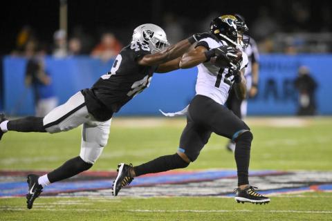 Jacksonville Jaguars wide receiver Marvin Hall runs after a catch with Las Vegas Raiders cornerback Sam Webb (48) defending during the Hall of Fame game on Thursday in Canton, Ohio. (DAVID RICHARD/Associated Press)