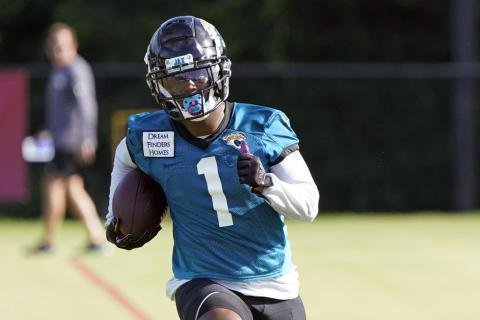 Jacksonville Jaguars running back Travis Etienne runs after a reception during practice on July 26 in Jacksonville. (JOHN RAOUX/Associated Press)