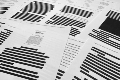 Pages from the affidavit by the FBI in support of obtaining a search warrant for former President Donald Trump's Mar-a-Lago estate are photographed Friday. U.S. Magistrate Judge Bruce Reinhart ordered the Justice Department to make public a redacted version of the affidavit it relied on when federal agents searched Trump's estate to look for classified documents. (JON ELSWICK/Associated Press)