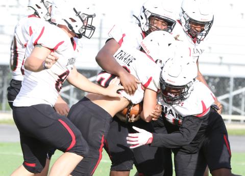 Fort White linebacker Davone Calhoun (right) and defensive tackle Jaylen Brown (above) make a tackle during a team scrimmage on Aug. 12. (MORGAN MCMULLEN/Lake City Reporter)