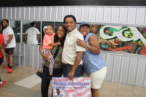 Ricky Jernigan (middle) stands with family members Ryleigh Jernigan (from left) as she’s held by Tiara Jernigan-Arline and Elena Jernigan-Highland during an election celebration party at Future Fitness on Tuesday night. (TONY BRITT/Lake City Reporter)