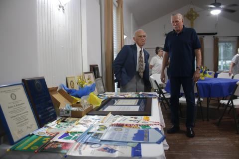 Perley Richardson (left), who has served as a Rotary Club member for 50 years, talks to Frank Loughran on Thursday evening during a ceremony honoring Richardson and his service to the organization. (TONY BRITT/Lake City Reporter)