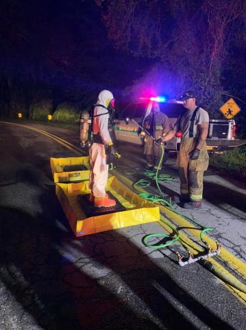 A first responder in a hazmat suit gets decontaminated after a traffic stop Wednesday night. (COURTESY LCFD)
