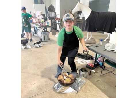 Lafayette 4-H’s AJ Swinson advanced to the state 4-H Tailgate and Grilling Competition after grilling pork chops at the district competition in July. (COURTESY)