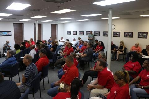 HAECO Americas employees and supporters wore matching red shirts to Thursday’s city council meeting. The city and HAECO are currently negotiating a renewal of HAECO’s lease at Lake City Gateway Airport. (MORGAN MCMULLEN/Lake City Reporter)