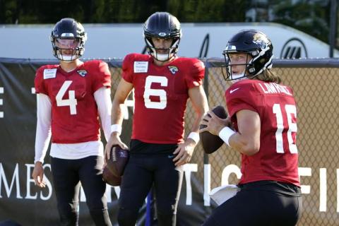 Jacksonville Jaguars quarterback Trevor Lawrence (16) runs through a drill as quarterbacks Kyle Sloter (4) and Jake Luton (6) look on during practice on Sunday in Jacksonville. (JOHN RAOUX/Associated Press)