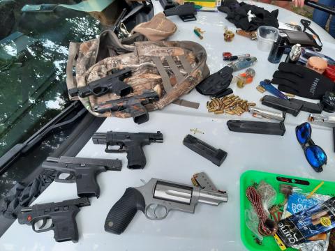 Firearms and drug paraphernalia are laid out after being confiscated from a trio of teens Tuesday. (COURTESY CCSO)