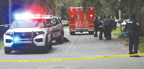 First responders arrived at the scene of a shooting incident around 5:05 p.m. Friday near Melrose Park Elementary School, cordoning off the intersection of SE Putnam Street and SE Baker Avenue. (TONY BRITT/Lake City Reporter)