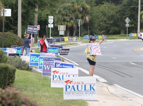 The entrance to the Supervisor of Elections office in Lake City shows a roadside packed with campaign signs on the first day of early voting. (MORGAN MCMULLEN/Lake City Reporter)