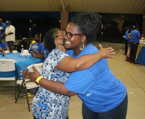 Chevella Young hugs supporter Linda Thomas at Darby Pavillion on Tuesday night after learning she was elected to the Lake City Council. (TONY BRITT/Lake City Reporter)