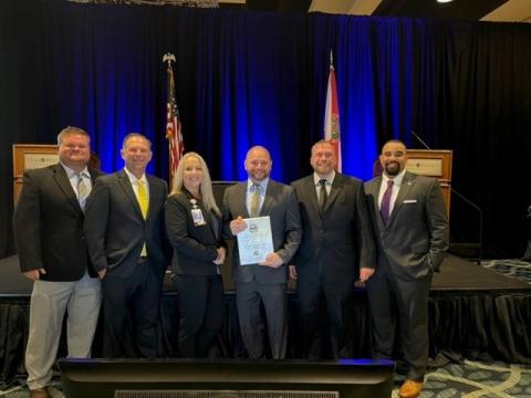 Dr. Colby Redfield, Century Ambulance’s Medical Director (center), was honored with the Raymond H. Alexander - EMS Medical Direction Award from the Florida Department of Health. Joining Dr. Redfield at the EMS Provider Awards on Wednesday were Brent Allen (from left), Matt Johnson, Karen Robeson, Aaron Smith and Alex Igartua. (COURTESY)