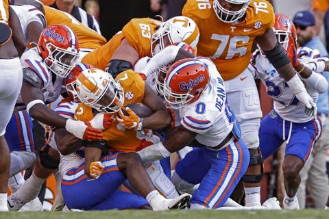 Tennessee running back Jabari Small (2) is stopped at the goal line by Florida safety Trey Dean III (0) and others during Saturday’s game in Knoxville, Tenn. (WADE PAYNE/Associated Press)