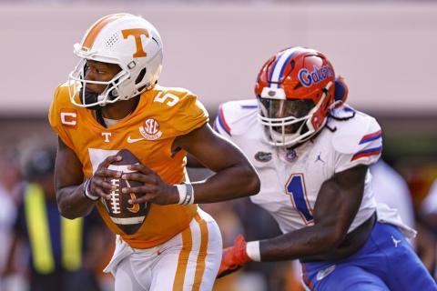 Tennessee quarterback Hendon Hooker runs for yardage while pursued by Florida linebacker Brenton Cox Jr. during Saturday’s game in Knoxville, Tenn.  (WADE PAYNE/Associated Press)