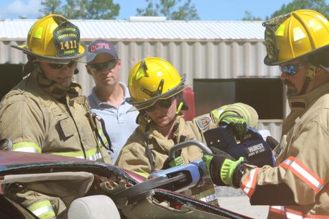 Columbia County firefighters Jessica Islam (center) and Bryan King (right) work with the Hurst Jaws of Life as Tyler Dorris (left) looks on Tuesday. (TONY BRITT/Lake City Reporter)