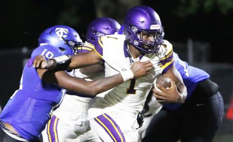 Columbia quarterback Tyler Jefferson fights through a tackle from Trinity Christian linebacker Tomarion McCray on Friday. (BRENT KUYKENDALL/Lake City Reporter)