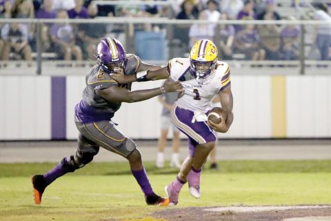Columbia quarterback Tyler Jefferson, trying to avoid a Union County defender last Friday, will try to deliver the Tigers their first win of the season Friday when Deland visits. (BRENT KUYKENDALL/Lake City Reporter)