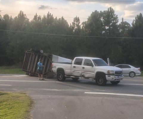 A trailer lies overturned on Branford Highway (State Road 247) on Tuesday evening after a crash following an improper U-Turn. (COURTESY GLENN ALLEN)