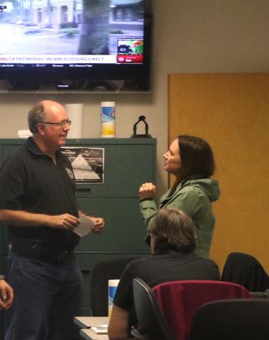 Emergency Management Director Shayne Morgan (left) and county spokeswoman Paula Vann converse Wednesday at the county’s Combined Communications Center. (MORGAN MCMULLEN/Lake City Reporter)