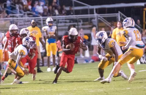 Fort White’s Najeeb Smith looks for a crease in the Newberry defense in the Indians’ 34-17 loss last week. (CHRISTINA FEAGIN/Special to the Reporter)