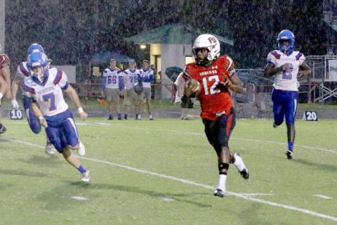 Fort White’s Najeeb Smith throws up a peace sign on his first rushing touchdown Friday night against Keystone Heights. (MORGAN MCMULLEN/Lake City Reporter)