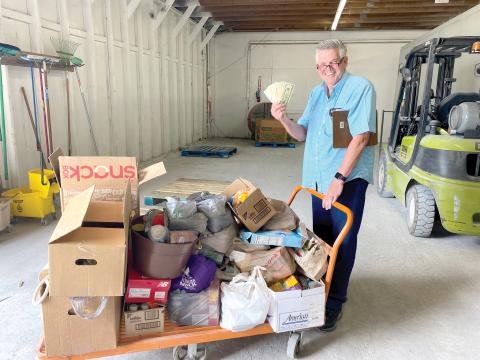Florida Gateway Food Bank Manager David Boozer smiles with a load of food and cash donations raised during the Suwannee Valley Food Fight to End Hunger. (COURTESY)